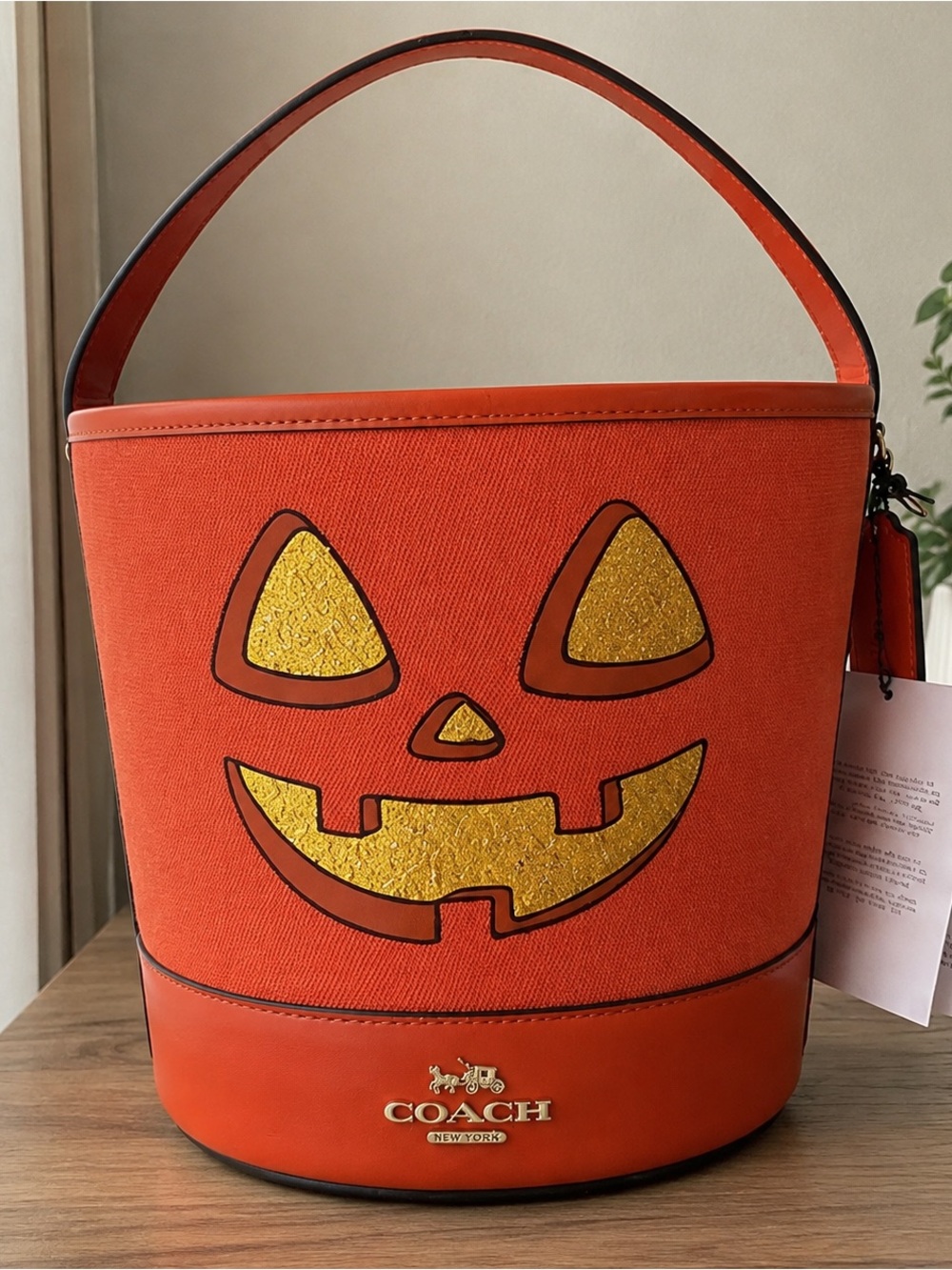 Coach Orange Bucket Shoulder Bag with Gold Jack-O'-Lantern Face